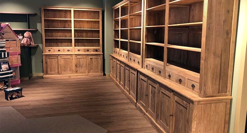 baby-winkel-inrichten Maatwerk teakhouten wandkasten met open vakken en lades in een babywinkel